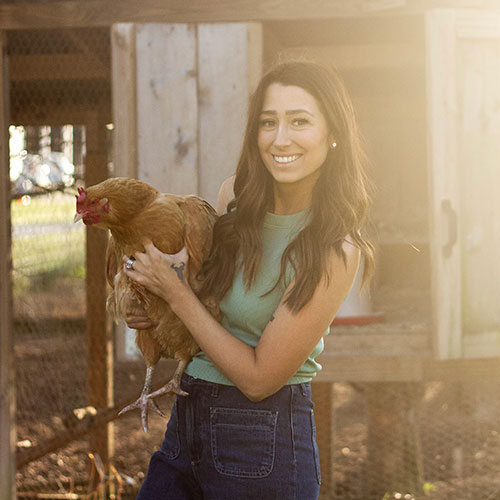 Ashley Till holding a chicken