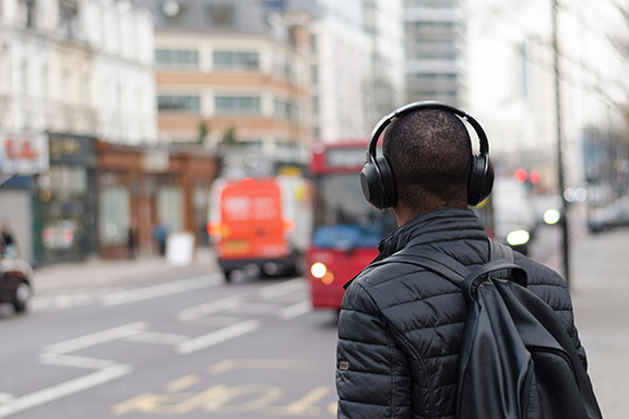 Man wearing headphones on a city street