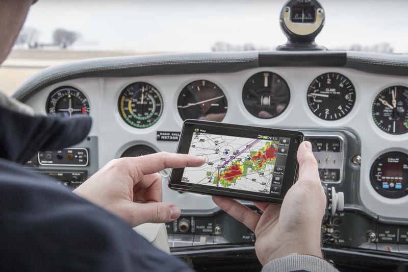 Pilot pointing at a Garmin Device