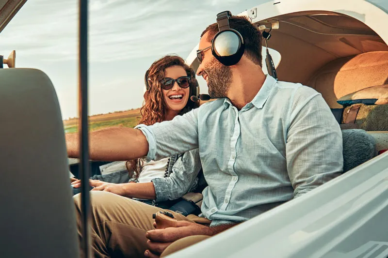 Two people in a cockpit, smiling