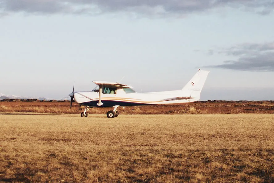 Small plane in a field of brown grass