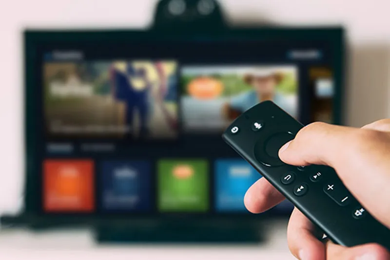 Amazon Fire TV remote in front of a TV screen