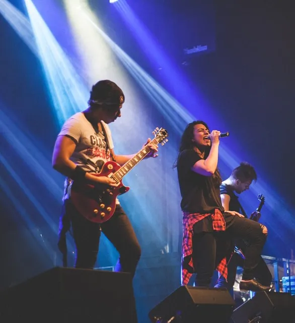 Singer and guitarist performing on stage.