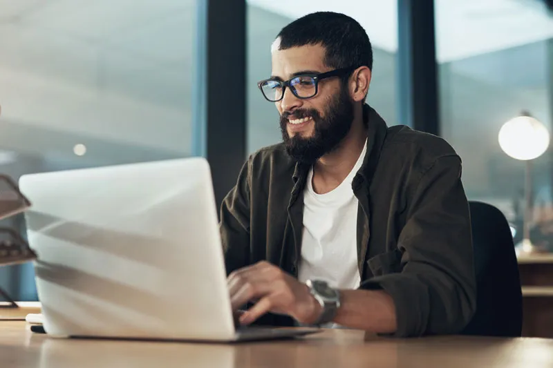 Man typing on laptop