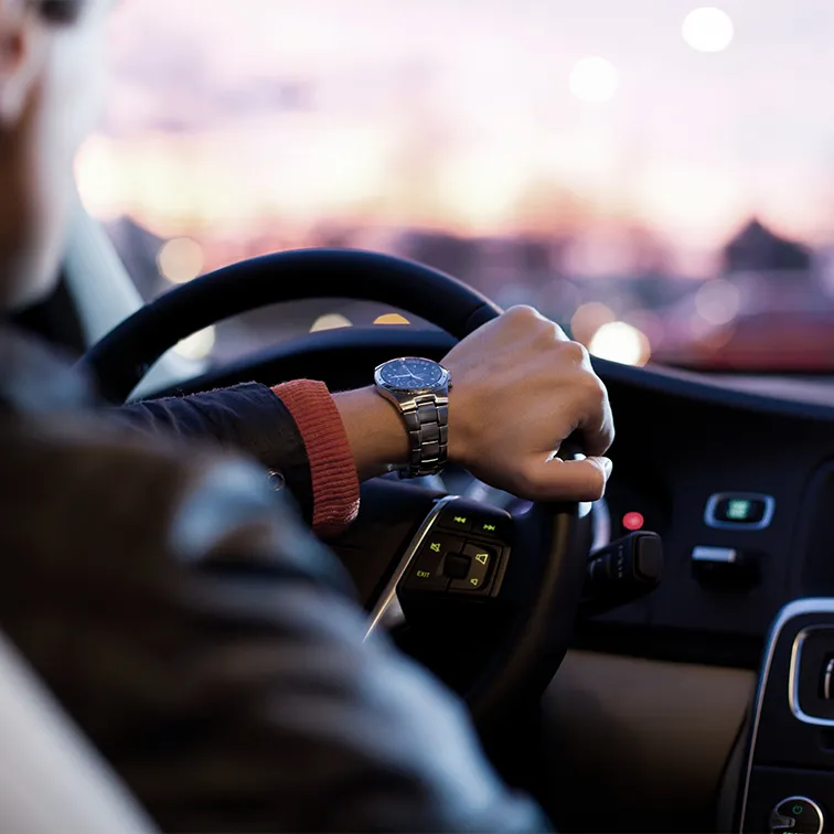 Close-up on someone's hand driving a car