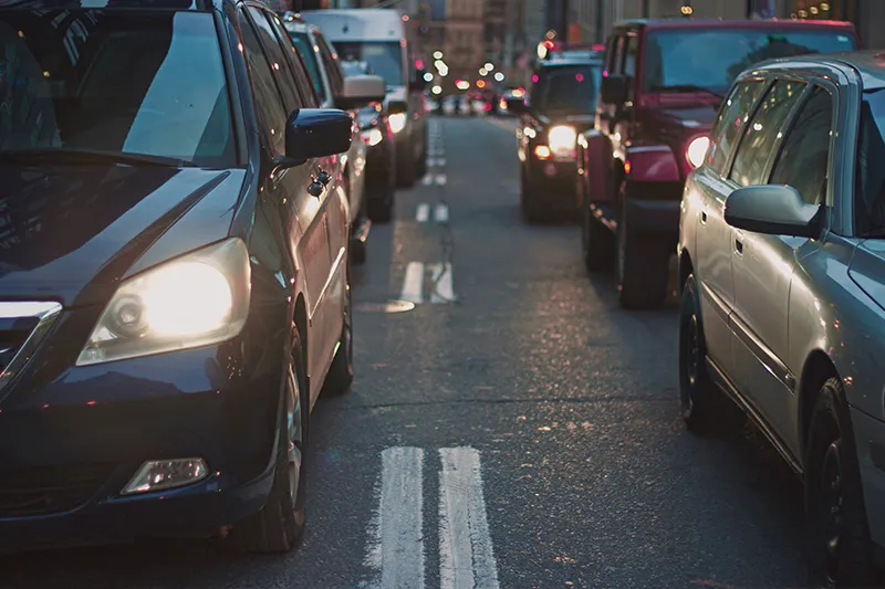 Cars sitting in traffic on a city road